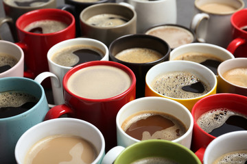 Many cups with tasty aromatic coffee, closeup