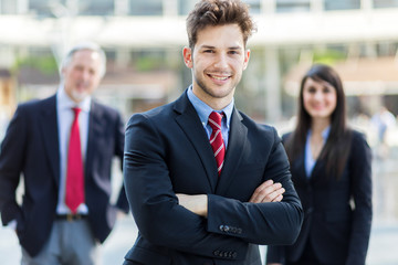 Business team smiling outdoor in a modern urban setting