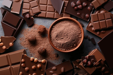 Poster - Chocolate pieces with cocoa powder in bowl and balls on wooden table