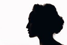 Silhouette Of Beautiful Young Woman With A Beautiful Hairdo. Black And White.