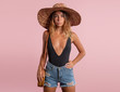 © South House Studio - woman in a hat and bag stands on an isolated
