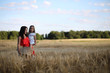© alexkich - Summer landscape and a girl on nature walk in the countryside.