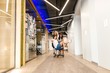 © pantovich - Women's business team at the break staged a competition rolling each other on office chairs along the corridor of the modern office