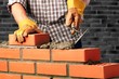 © BillionPhotos.com - Worker builds a brick wall