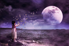 Asian Girl Playing With Soap Bubbles. Super Moon Behind Partial Cloud On Sky.