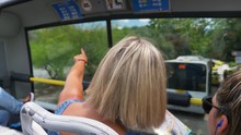 Two Tourists Women Riding On Open Top Floor Of Bus Sightseeing In Athens In A Sunny Day. A Mother And Her Daughter Travelling And Looking At The Map Of A City. Women Talking And Pointing With Finger.