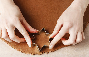 Canvas Print - Woman making gingerbread cookies in star shape.