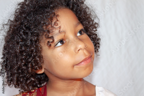 Portrait Of A Mixed Ethnisity Little Girl With Curly Hair A