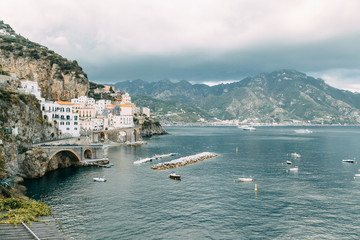 The Amalfi coast and the mountain slopes with plantations of lemons. Panoramic view of the city and nature of Italy. Evening landscapes and winding roads