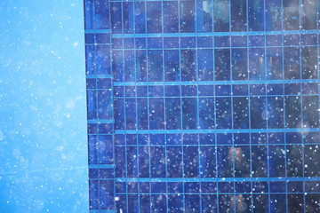 Wall Mural - snow in a night city skyscrapers / seasonal landscape winter city, snowfall against a background of skyscrapers