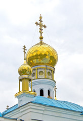 Wall Mural - Golden, church domes and decorated orthodox cross