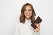 © Martin Villadsen - portrait of young happy woman holding chocolate looks in camera