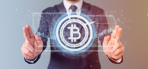 Poster - Man holding a technology Bitcoin icon on a circle 3d rendering