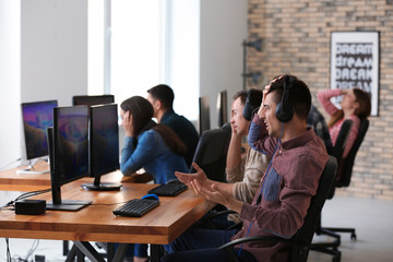 Poster - Young people playing video games at tournament