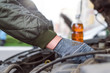 © Dmitriy - Car mechanic pouring a new motor oil into engine.