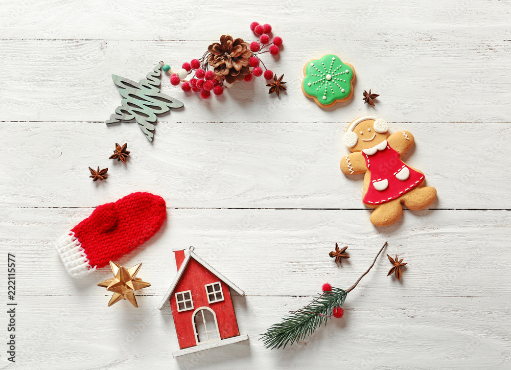 Frame made of Christmas decor on white wooden background