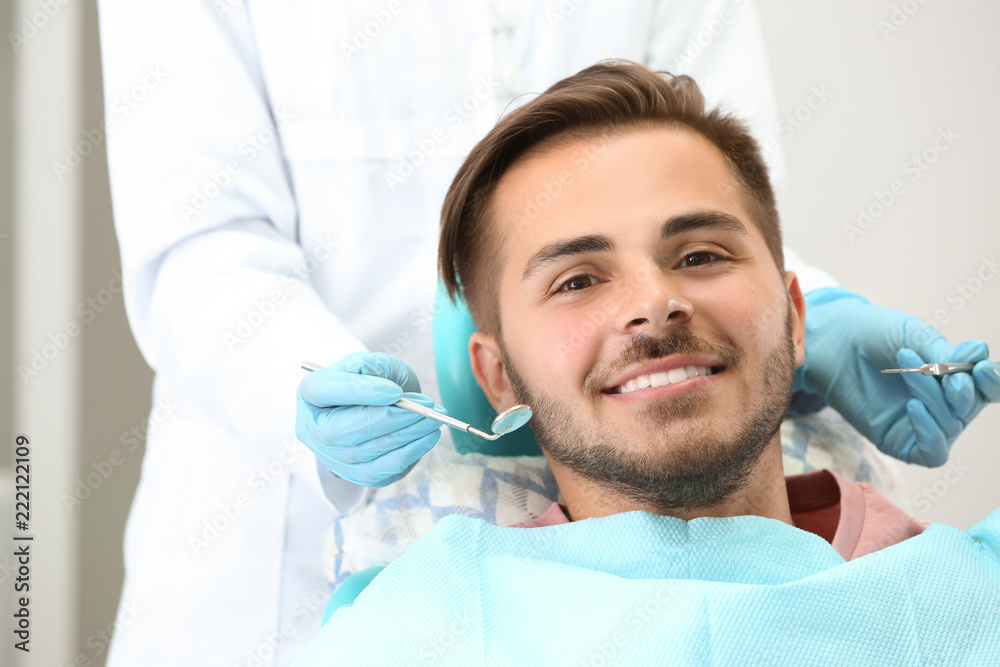Dentist examining patient's teeth in clinic