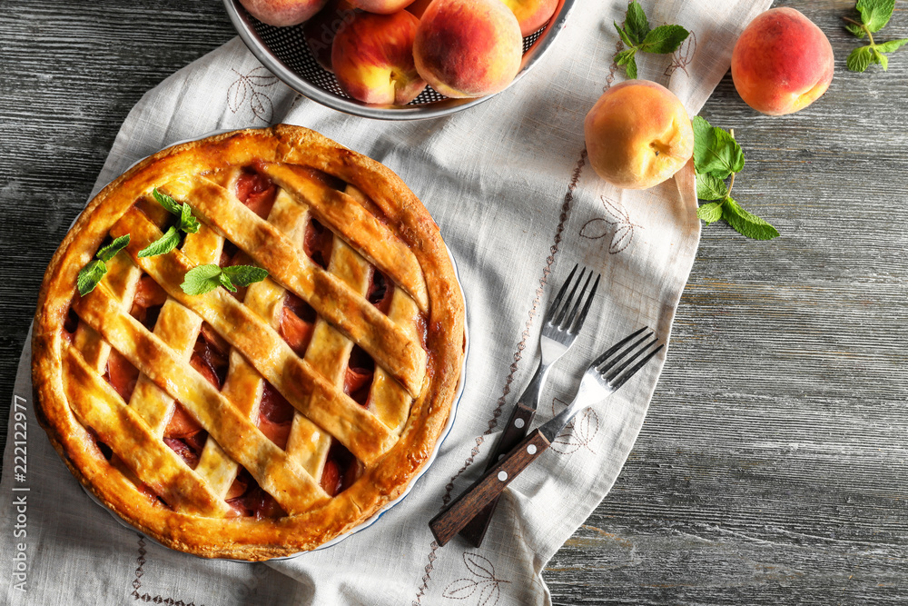 Delicious peach pie on wooden table