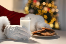 Santa Claus Eating Cookies And Drinking Milk At Table, Closeup