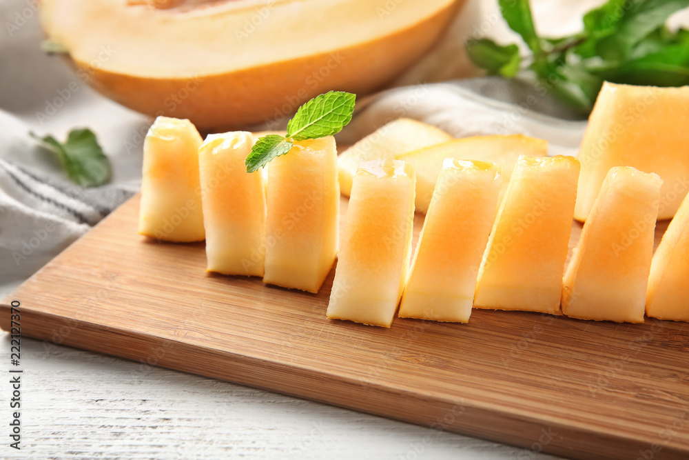 Sliced ripe melon on wooden board