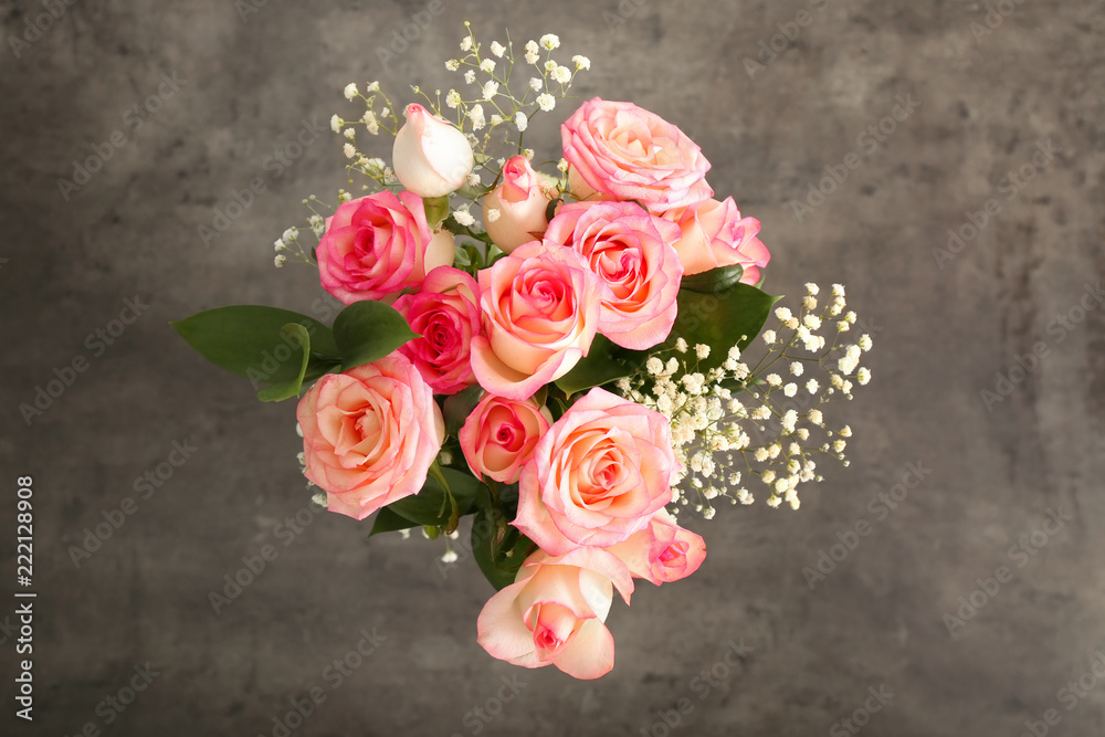 Bouquet of beautiful roses on grey background