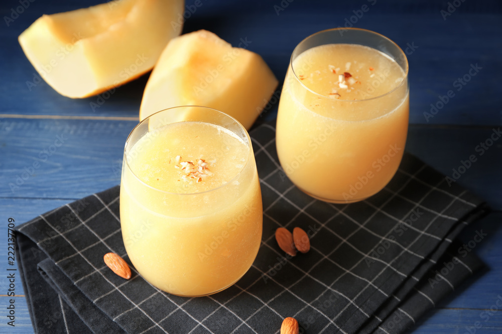 Glasses with delicious melon smoothie on wooden table