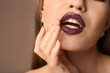 © Pixel-Shot - Beautiful young woman with dark lipstick on color background, closeup