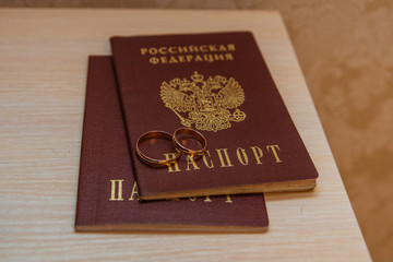 Wedding ring. Two gold romantic rings of the bride and groom and passports of the Russian Federation