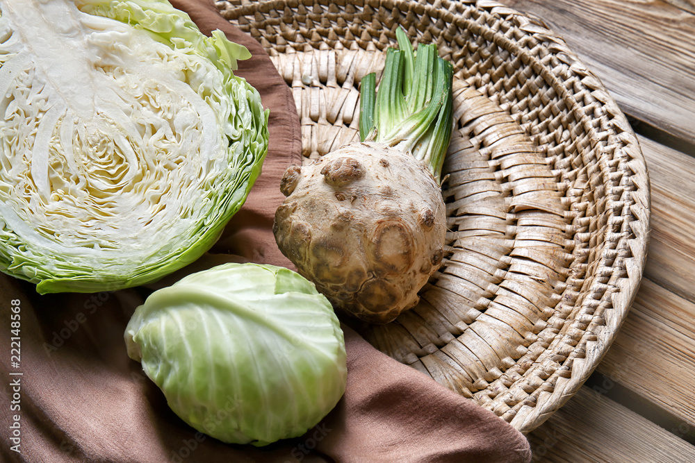 Ripe cabbage and celery on wicker plate