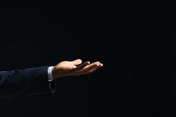 Businessman holding something on dark background