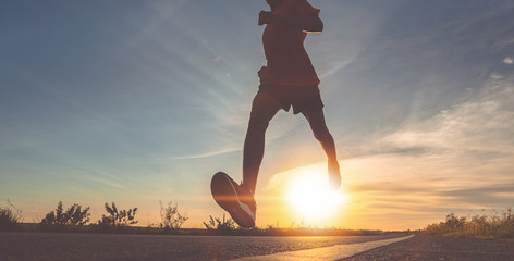 Wall Mural - Athlete runner feet running on road