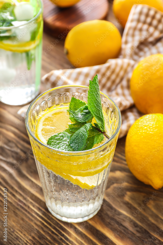 Glass of fresh lemonade on wooden table