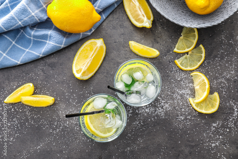 Glasses of fresh lemonade on grey table