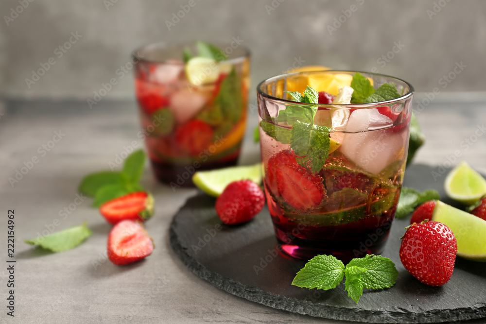 Glass of fresh strawberry lemonade on slate plate
