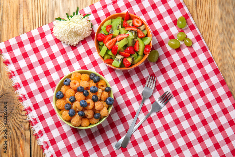 Delicious fruit salads in bowls on table