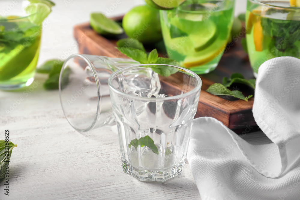 Empty glasses with mint on light table