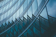 © VALERYIA - Abstract business modern city urban futuristic architecture background. Real estate concept, motion blur, reflection in glass of high rise skyscraper facade, toned blue picture with bokeh