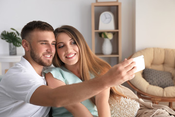 Canvas Print - Happy loving couple taking selfie at home