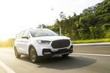 White suv sedan flying fast on the highway