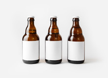 Three Brown Beer Bottles With Blank Labels.