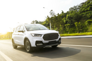 Wall Mural - White suv sedan flying fast on the highway