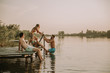 © BGStock72 - Group of young people having fun on pier at the lake