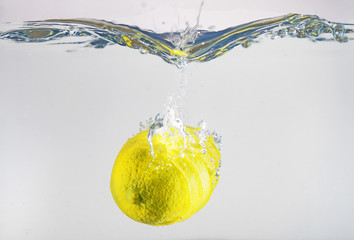 Wall Mural - Lemon falling into the water. Suitable for advertisement.