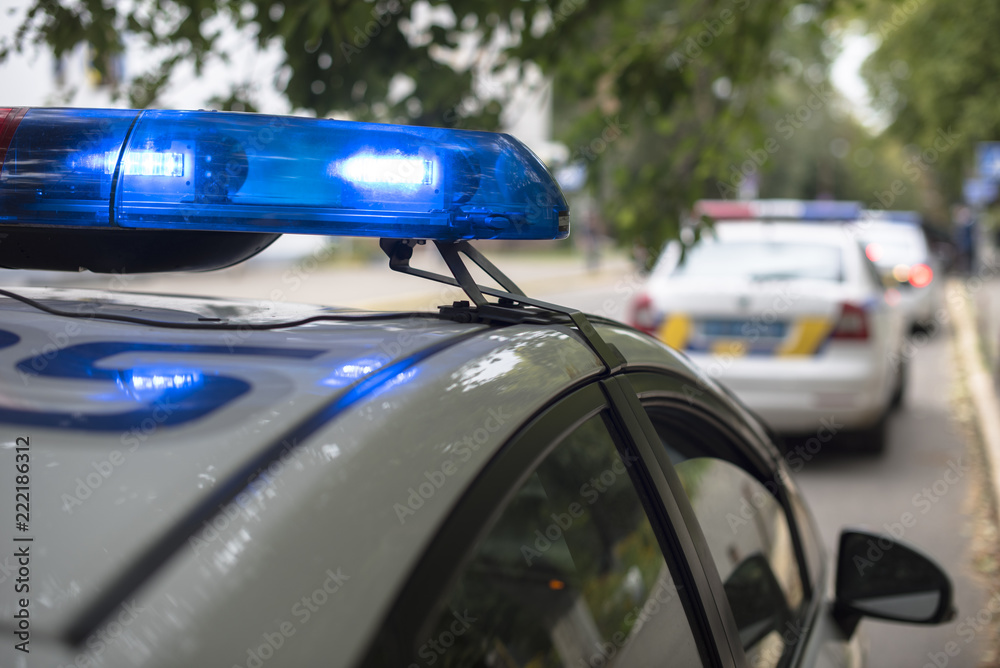 the patrol car with flashing lights on