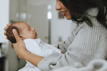 Wall Mural - mother holding her infant baby