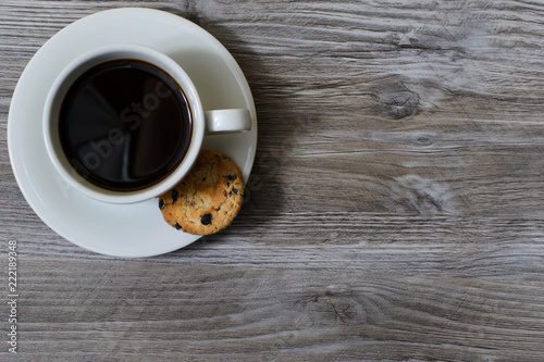 Fotografie, Obraz A cup of hot coffee on a saucer with a chocolate cookie