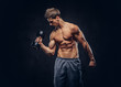© Fxquadro - Handsome shirtless man with stylish hair and muscular ectomorph body doing the exercises with dumbbells.