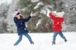 © MNStudio - Two adorable little girls having fun together in beautiful winter park. Beautiful sisters playing in a snow.