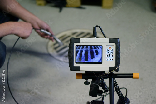 Fotomural Man start using sewer inspection camera.