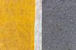 © manoonpan - Background of yellow black strips . Dark grey asphalt road divided by yellow paint. yellow black background